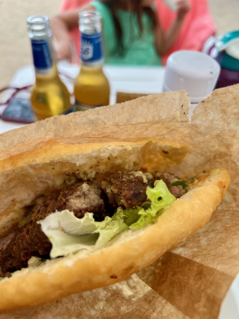 Eating a warm Bokit right on the beach